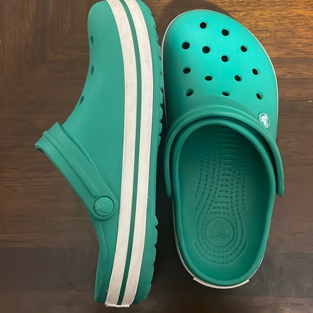 Gently worn crocs in a warm green